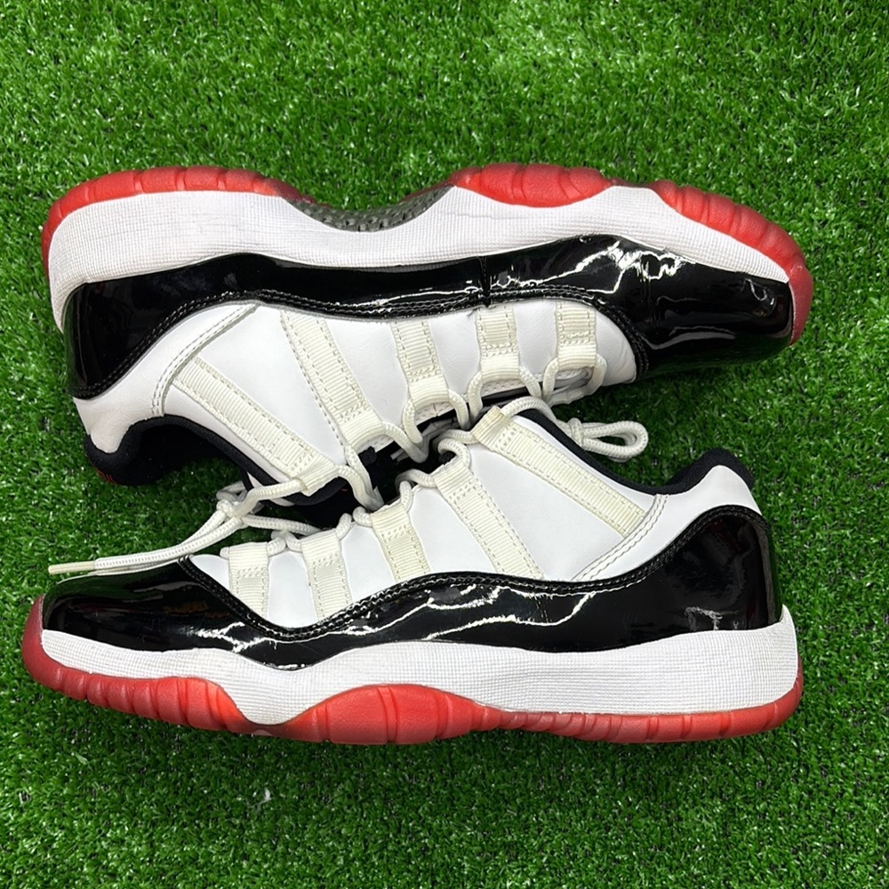 Stylish White and Black Sneakers with Red Soles